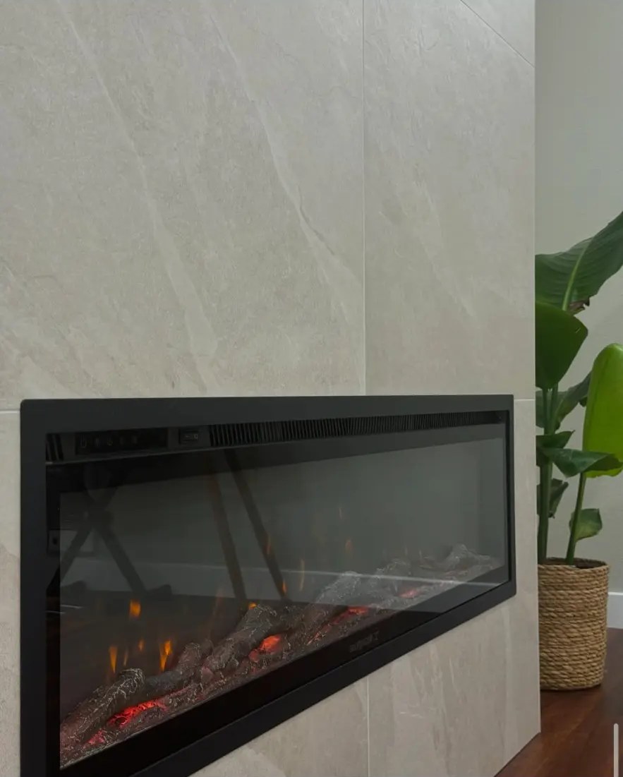 Linear electric fireplace set in large-format stone-look tile
