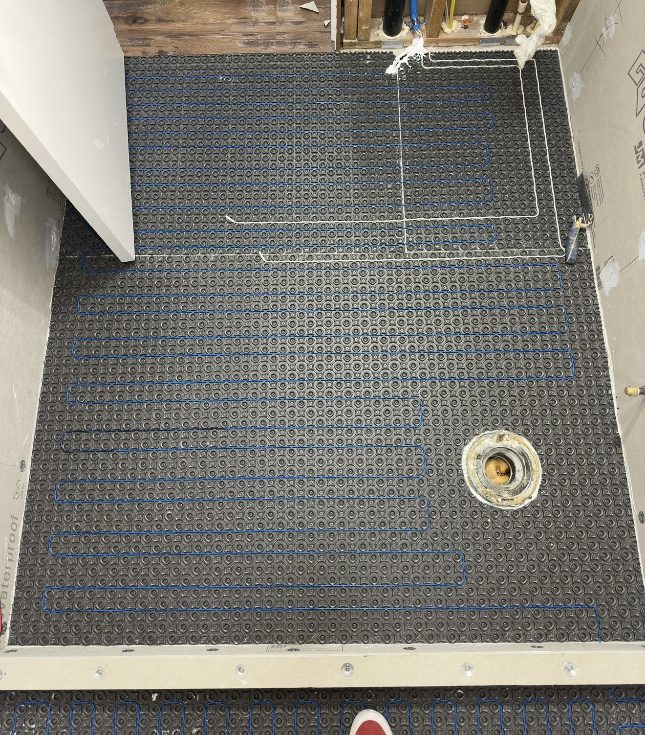 Heated floor system installed across a bathroom floor ready for tile