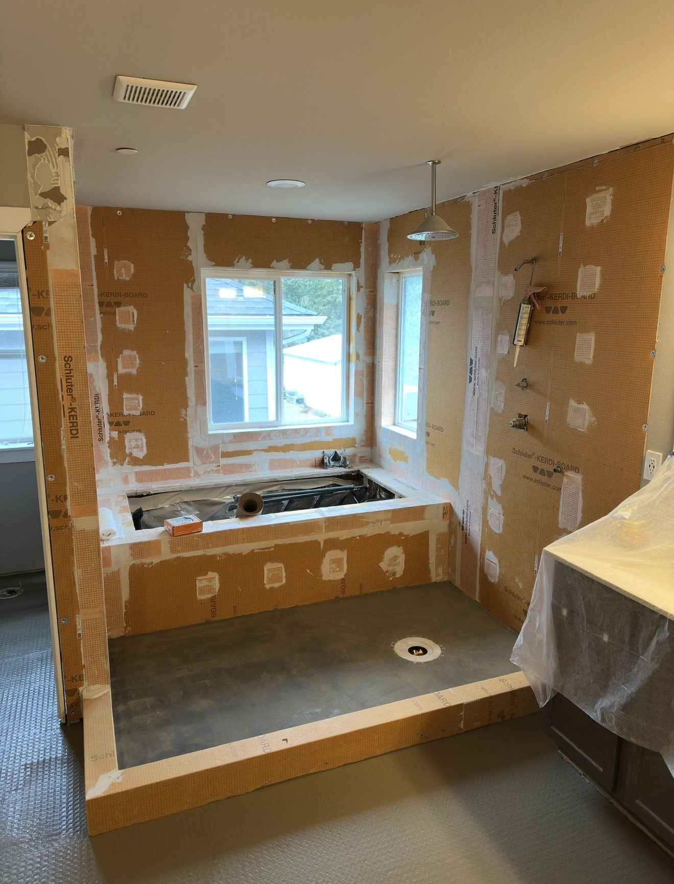 Master bath tub deck and shower walls waterproofed with bonded board before tile
